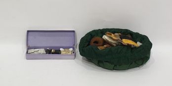 Various sewing implements, including vintage threads, tools, scissors and other items in a draw