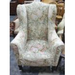 19th century wing back armchair in loose foliate covers