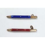 Two gold-coloured metal and enamel miniature bridge/pendant pencils, one with blue and white spotted