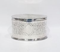 Electroplated biscuit tin of oval form, scrolling foliate engraving