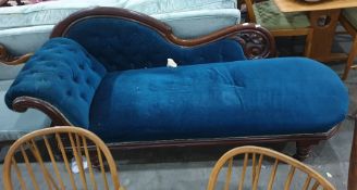 Mahogany Victorian chaise longue with blue ground upholstery, turned supports to brown china castors