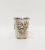 White metal cup with flared rim, vine fruit repousse decoration, marked 925, 3oz approx, 8cm high