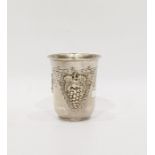 White metal cup with flared rim, vine fruit repousse decoration, marked 925, 3oz approx, 8cm high