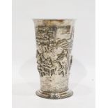 White metal cup with flared rim and of tapering form, raised on a circular foot with repousse