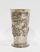 White metal cup with flared rim and of tapering form, raised on a circular foot with repousse