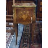 Continental, probably French, cabinet with parquetry inlaid top featuring flowers in a vase, moulded