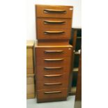 A 20th century bedside chest of three drawers in teak raised upon plinth base and matching narrow