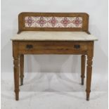 A 19th century tile-back washstand with rectangular marble top, single drawer to turned supports,