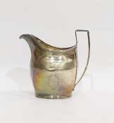 George III silver cream jug, helmet-shaped and engraved with stiff leaves, having reeded angular