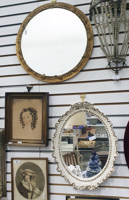 Circular wall mirror and an oval plated wall mirror (2)