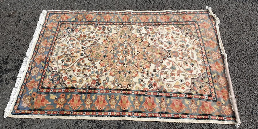 Eastern rug, cream ground field with peach ground central medallion, allover decoration on a three