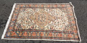 Eastern rug, cream ground field with peach ground central medallion, allover decoration on a three