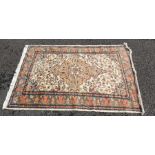 Eastern rug, cream ground field with peach ground central medallion, allover decoration on a three