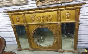 19th century giltwood wall mirror having cavetto and ball moulded cornice, the frieze embossed