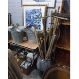 Galvanised milk churn and bath containing a selection of vintage tools, including rakes, hoes,