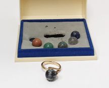 Gold-coloured metal dress ring set with spherical raised claw set polished hardstone and having five