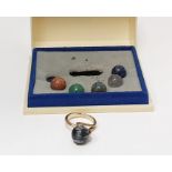 Gold-coloured metal dress ring set with spherical raised claw set polished hardstone and having five