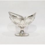 Victorian silver boat-shaped sucriere with beaded swing handle and floral repousse decoration, on