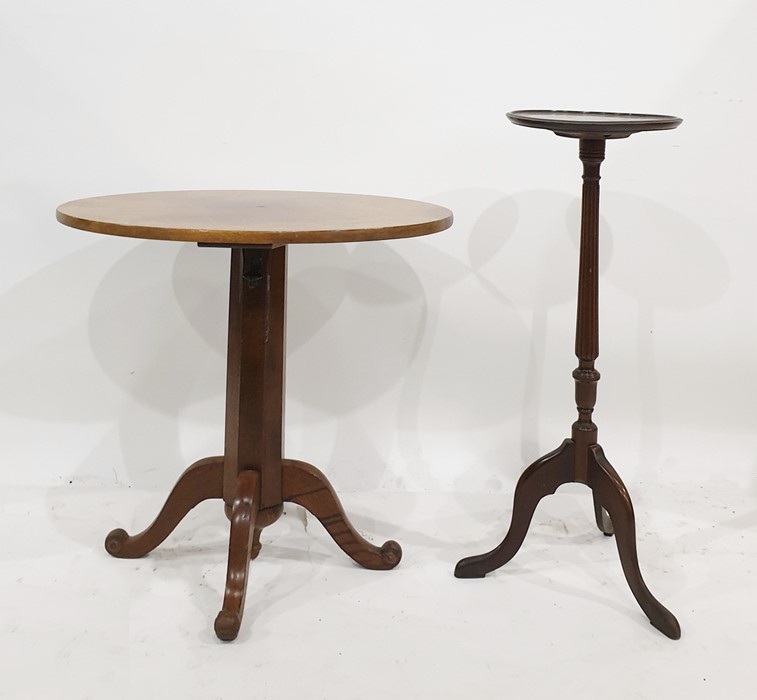 Mahogany plant stand and an oval walnut centre table on faceted telescopic column support, to four