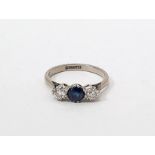 18ct white gold and platinum, sapphire and diamond ring set central circular sapphire flanked by two