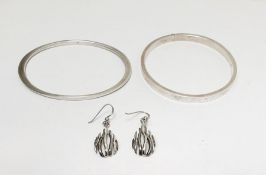 Two silver-coloured metal bangles and pair drop earrings