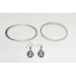 Two silver-coloured metal bangles and pair drop earrings