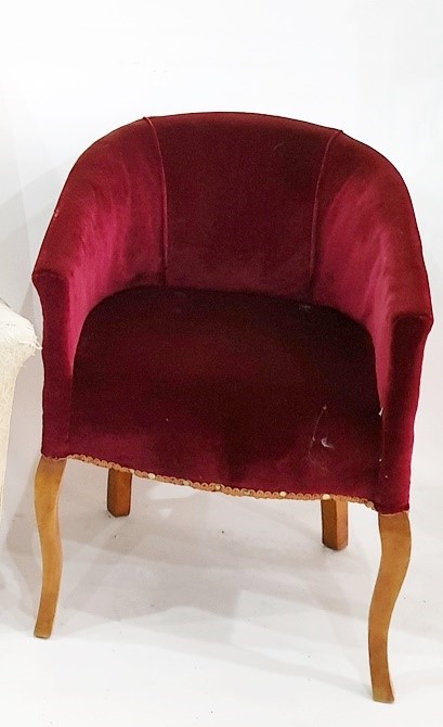 Early 20th century tub chair in plum ground upholstery with shaped cabriole supports