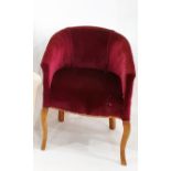 Early 20th century tub chair in plum ground upholstery with shaped cabriole supports