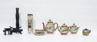 Japanese Satsuma part tea service painted in gilt with figures before pavillions, in garden