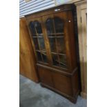 Twentieth century walnut cabinet, glazed doors, enclosing shelves, two cupboard doors under,