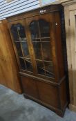 Twentieth century walnut cabinet, glazed doors, enclosing shelves, two cupboard doors under,