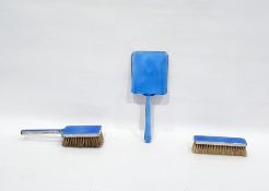 Silver plate and blue enamel backed dressing table set comprising hand mirror, hairbrush and clothes