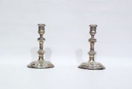 Pair of silver Georgian-style candlesticks with turned bulbous stems, raised on circular foot,