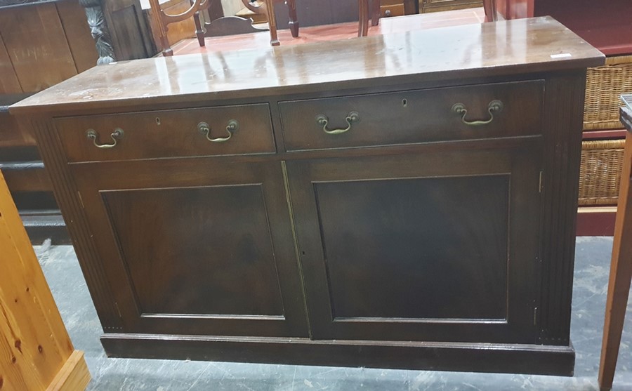 Mahogany sideboard, two drawers above two cupboard doors, flanked by fluted pilasters on plinth base