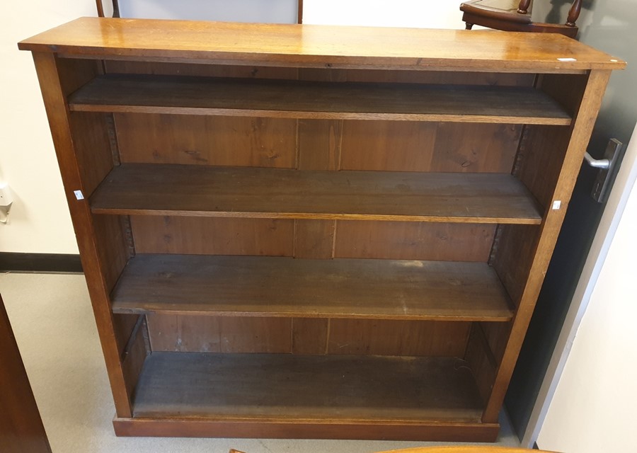 A mahogany open bookcase of four shelves to plinth base 125 x 124.5 cm