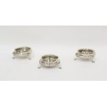 Set of three Victorian silver salts with embossed foliate decoration, raised upon four paw feet