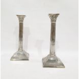 Pair of Edwardian Corinthium column silver candlesticks with gadrooned borders, fluted columns, on