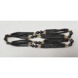String of hematite beads with baroque pearl and gold-coloured beads