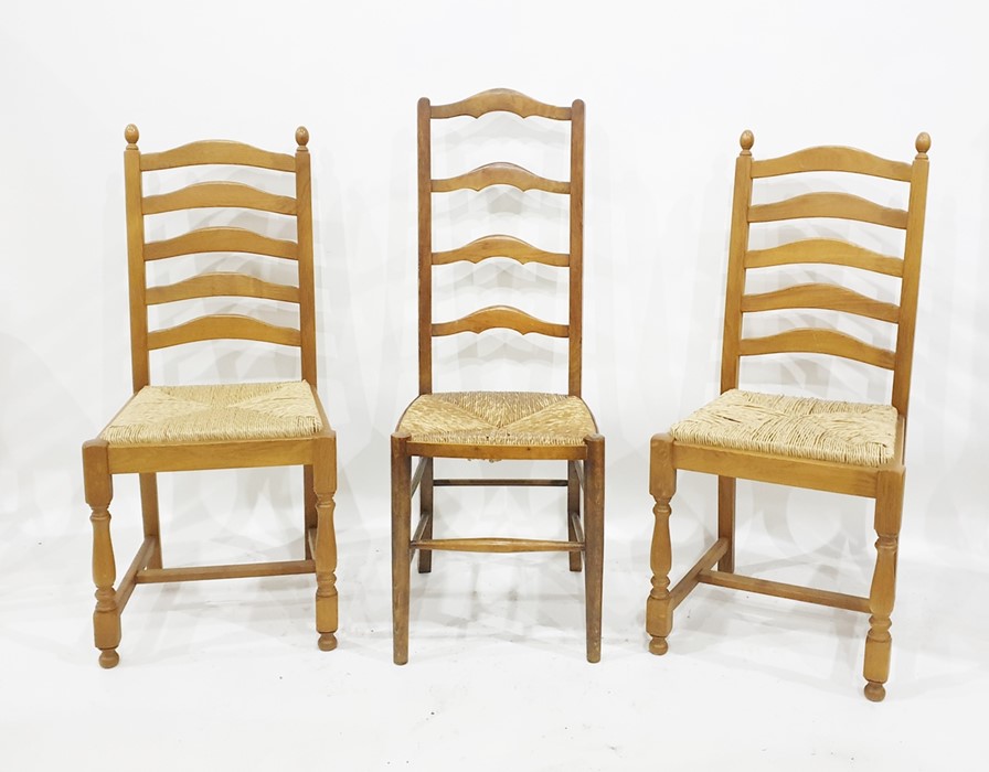 Four oak ladderback dining chairs with rushed seating and two further ladderback dining chairs (6)