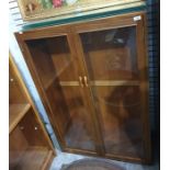 Twentieth century teak display cabinet, two glazed doors, glass shelves, 89 x 131.5 cms