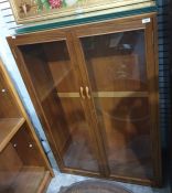 Twentieth century teak display cabinet, two glazed doors, glass shelves, 89 x 131.5 cms