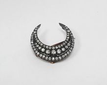 Diamond crescent brooch, having three rows of graduated old cut diamonds in white metal and gold-