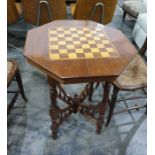 Early 20th century walnut and chessboard inlaid topped centre table raised upon turned and block