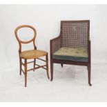 Edwardian mahogany square-back bergere tub chair on square tapering supports and castors and a