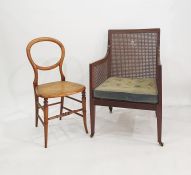 Edwardian mahogany square-back bergere tub chair on square tapering supports and castors and a