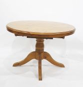 20th century pine extending dining table on central pedestal, four reeded supports