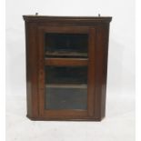 Oak wall-hanging corner cabinet, the single glazed door enclosing three shelves