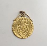 George III gold spade guinea pendant with scroll mount (date worn 178?)