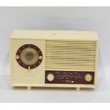 Ekco radio, model number A244, within an ivory-coloured plastic case with claret ground panels, 31cm