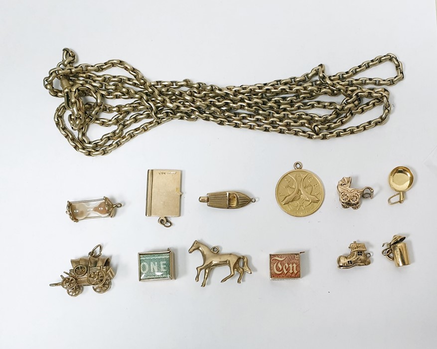 Quantity of gold charms to include British passport, pram, boot, cased banknotes and others and a